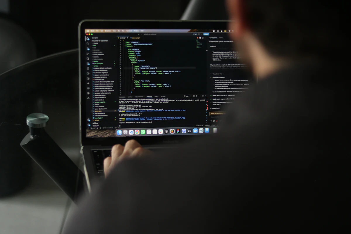 A developer working on source code at a laptop